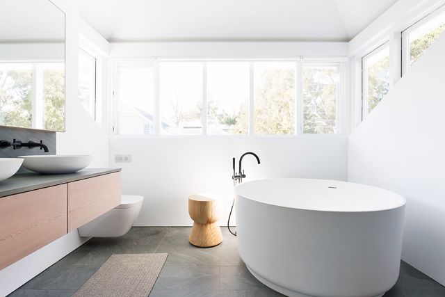 Bedonia Honed vanity and floor with Agape In Out bath. Avalon Residence by Ali Griffiths