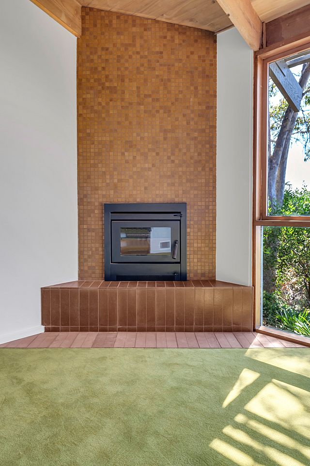 Arrotato Da Crudo Tobacco floors and Vixel, glass mosaic with terracotta hues, as feature fireplace wall