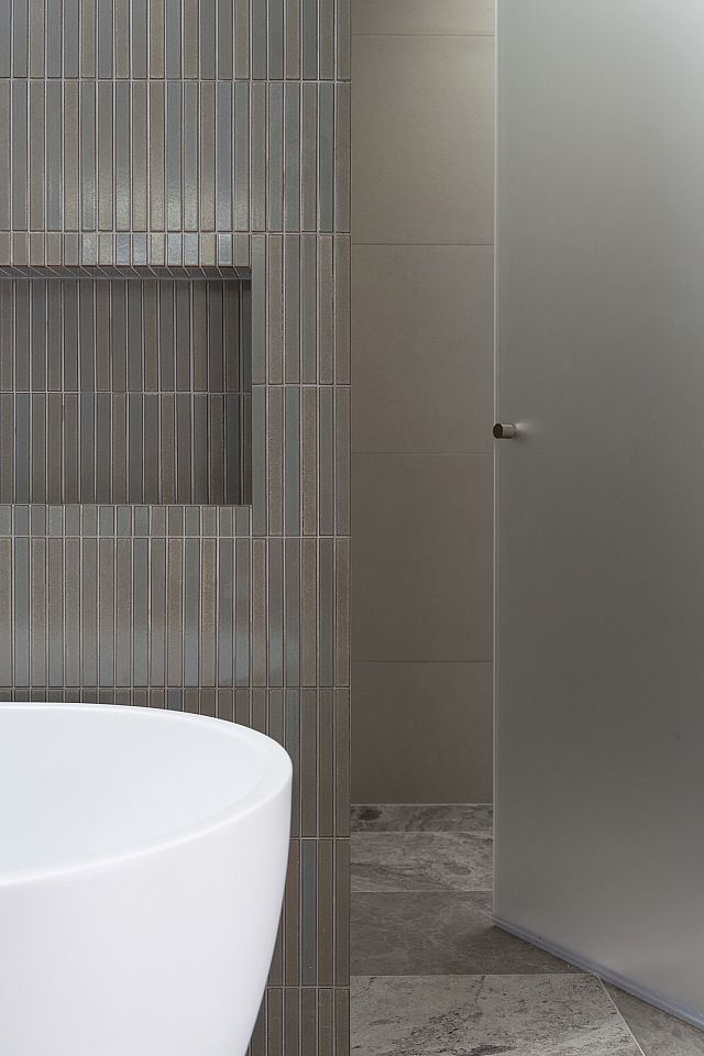 Nagi Border, sage green japanese ceramic wall mosaic, and Teragio, greige marble tile, used at Canberra Residence by Collins Pennington. Photography by Kasey Funnell Photography