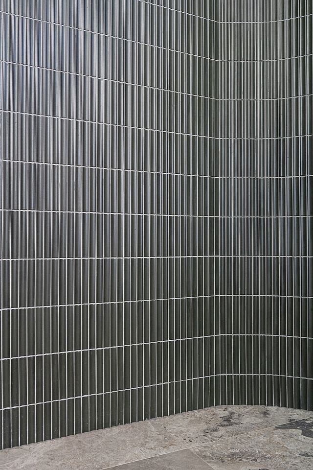 Yukasumi, green japanese ceramic wall mosaic, and Teragio, greige marble tile, used at Canberra Residence by Collins Pennington. Photography by Kasey Funnell Photography