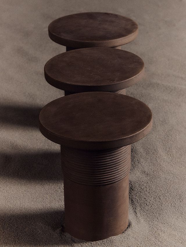Bound Table designed by Locki Humphrey for New Volumes in marrone terracotta with glass top