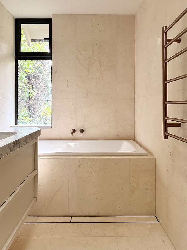 Crema Lyra floor and walls. Interior Design by Chanel Sohier. Architecture by Peter Rush. Build by Layden Projects.