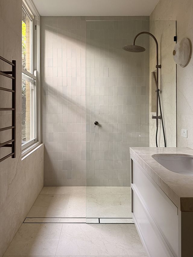 Crema Lyra ​floor with with ​Arute Shinrin White ​wall and Remelio​ vanity top. Interior Design ​by Chanel Sohie​r. Architect​u​re by Peter Rush​. Build​ by Layden Projects​.