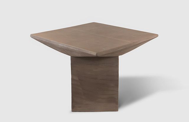 New Volumes Pitcher Table Marrone — sculptural terracotta table in brown, with geometric faceted top and monolithic pedestal base