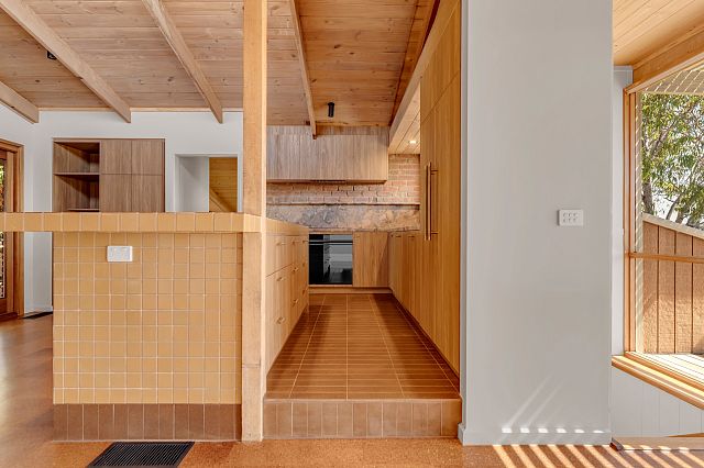 Magente, a strong and durable quartzite with purple hues, as kitchen benchtop and splashback,Arrotato Da Crudo Tobacco terracotta floors and on the island INAX Kohsuta Mustard 1442, a Japanese Ceramic mosaic.