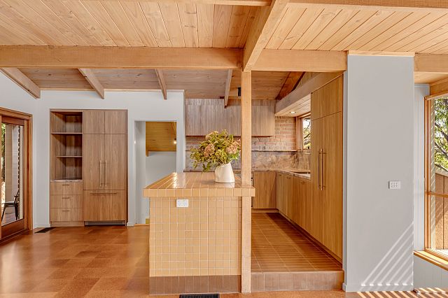 Magente, a strong and durable quartzite with purple hues, as kitchen benchtop and splashback,Arrotato Da Crudo Tobacco terracotta floors and on the island INAX Kohsuta Mustard 1442, a Japanese Ceramic mosaic.