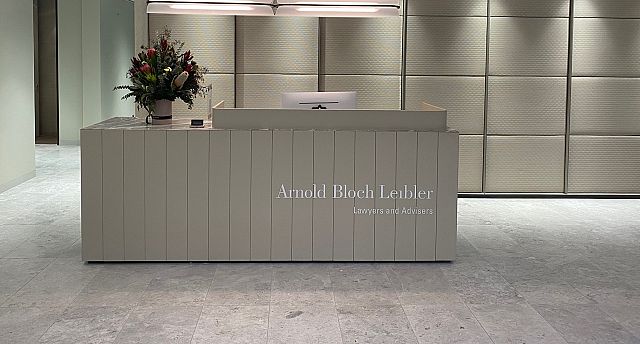 Perla Argento tiles with Vigo Lena stone detail on the reception desk. Design and Architecture by Bates Smart. Build by Shape..jpg